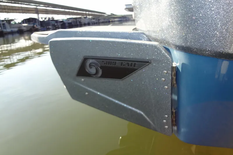 Slide: The Image of 2021 Axis A24 boat with Surf Gate feature, docked on calm water. - 52