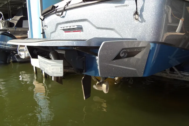 Slide: The Image of 2021 Axis A24 boat with Surf Gate and Power Wedge features, docked in water. - 54