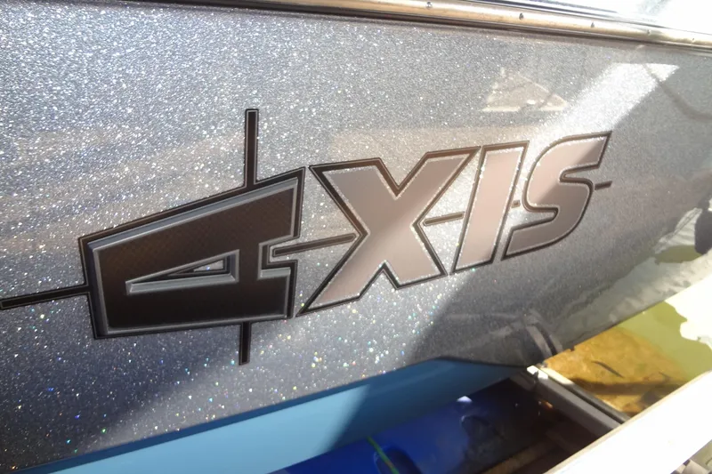 Slide: The Image of 2021 Axis A24 boat logo on a sparkling metallic surface. - 6