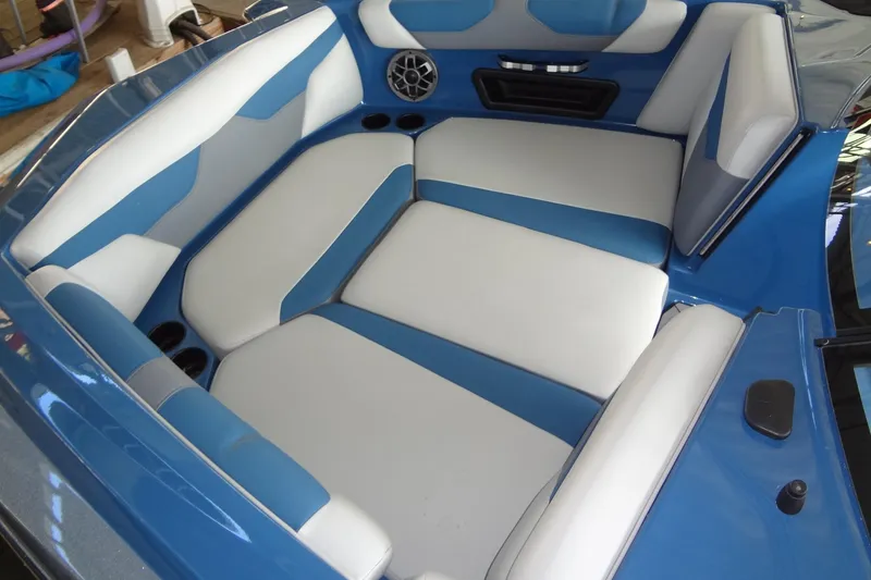Slide: The Image of 2021 Axis A24 boat interior with blue and white cushioned seating. - 7