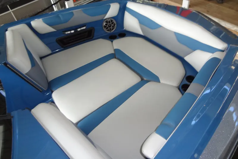 Slide: The Image of 2021 Axis A24 boat interior with blue and white seating and speaker system. - 8