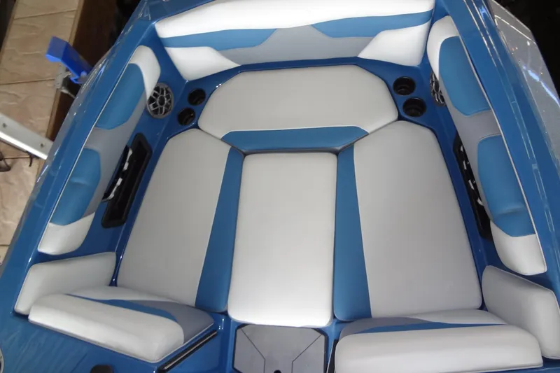 Slide: The Image of 2021 Axis A24 boat interior with blue and white cushioned seating. - 9