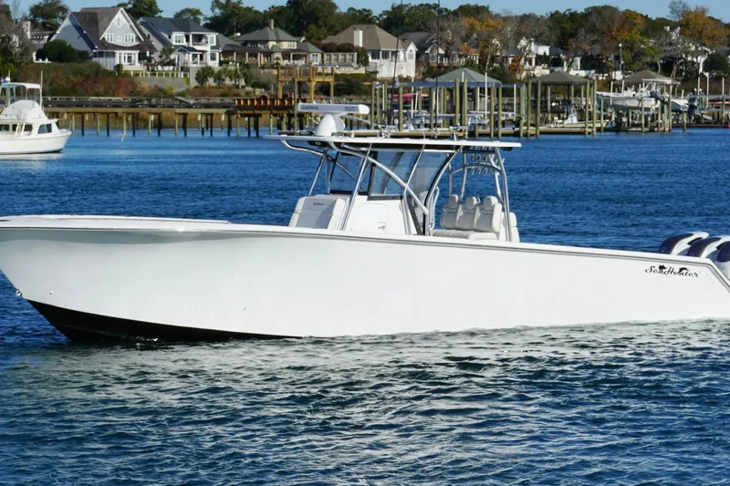 The Image of 2024 SeaHunter 39 Tournament boat on calm water near a marina. - 1