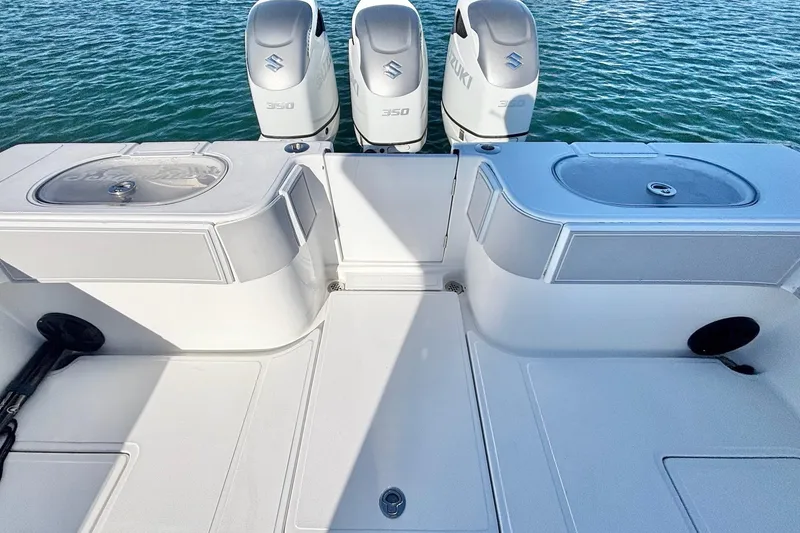 Slide: The Image of 2024 SeaHunter 39 Tournament boat with triple Suzuki 350 engines on water. - 18