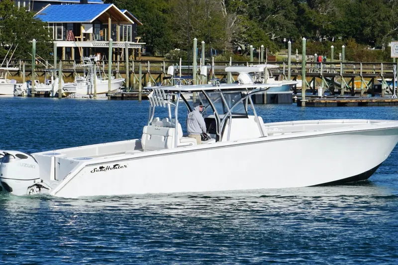 Slide: The Image of 2024 SeaHunter 39 Tournament boat cruising near a marina with waterfront homes. - 3