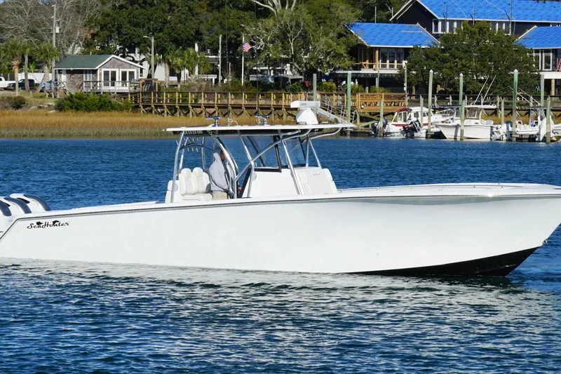 Slide: The Image of 2024 SeaHunter 39 Tournament boat cruising on a calm waterfront. - 7