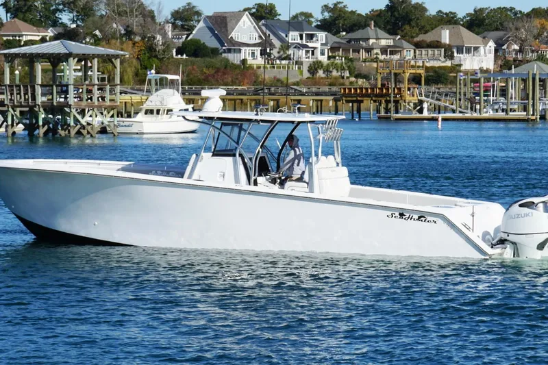 Slide: The Image of 2024 SeaHunter 39 Tournament boat cruising on a scenic waterfront. - 8