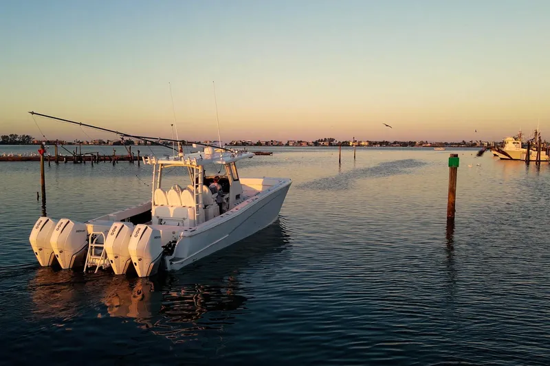 Slide: The Image of 2022 World Cat 400 CC-X boat cruising at sunset on calm waters. - 11