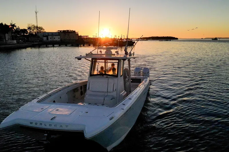 Slide: The Image of 2022 World Cat 400 CC-X boat cruising at sunset on calm waters. - 2