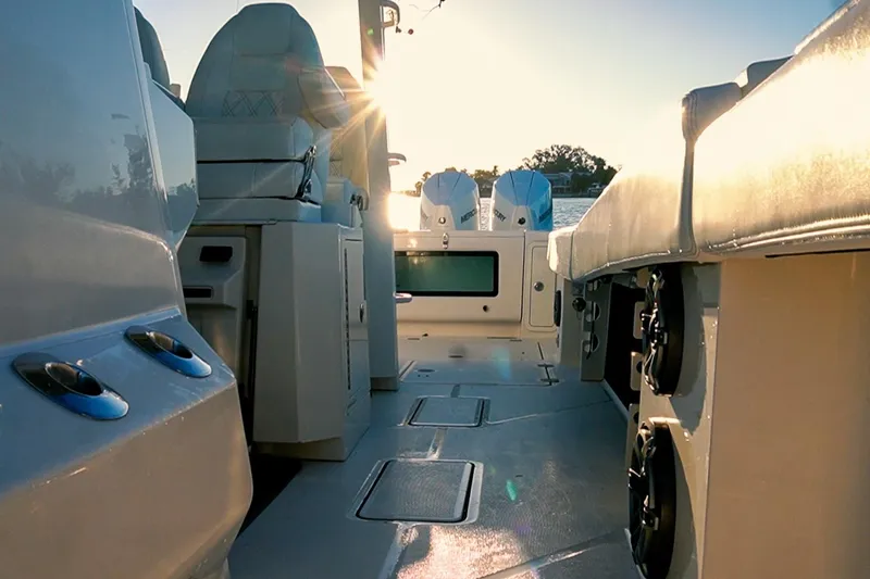 Slide: The Image of 2022 World Cat 400 CC-X boat interior with seating and dual engines at sunset. - 23