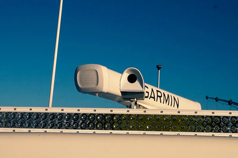 Slide: The Image of Garmin radar on 2022 World Cat 400 CC-X boat against clear blue sky. - 24