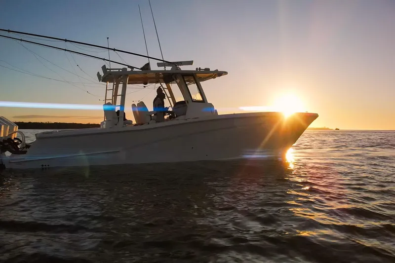 Slide: The Image of 2022 World Cat 400 CC-X boat at sunset on the water. - 27