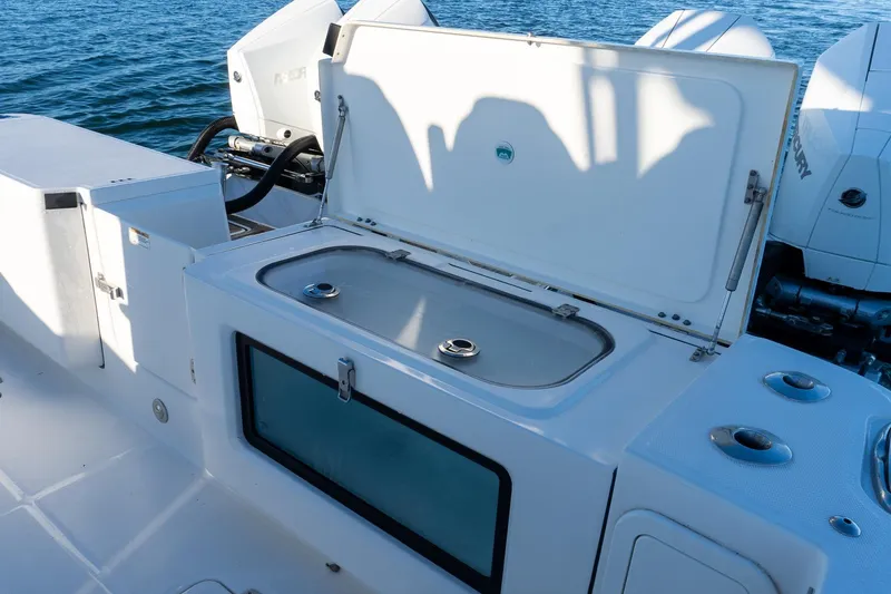 Slide: The Image of Open storage compartment on 2022 World Cat 400 CC-X boat, with ocean backdrop. - 34