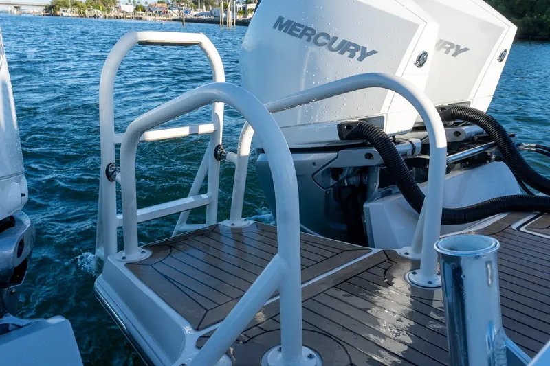 Slide: The Image of World Cat 400 CC-X 2022 boat with Mercury engines, featuring a swim platform and ladder. - 39