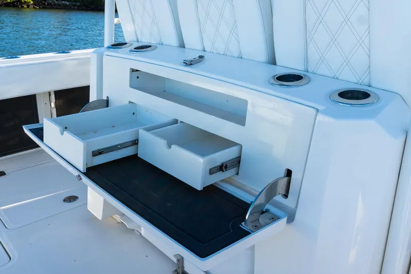 Slide: The Image of 2022 World Cat 400 CC-X boat storage drawers and cup holders on deck. - 40