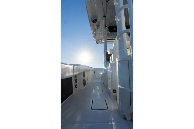 Slide: The Image of 2022 World Cat 400 CC-X boat interior with sunlit deck and clear sky. - 44