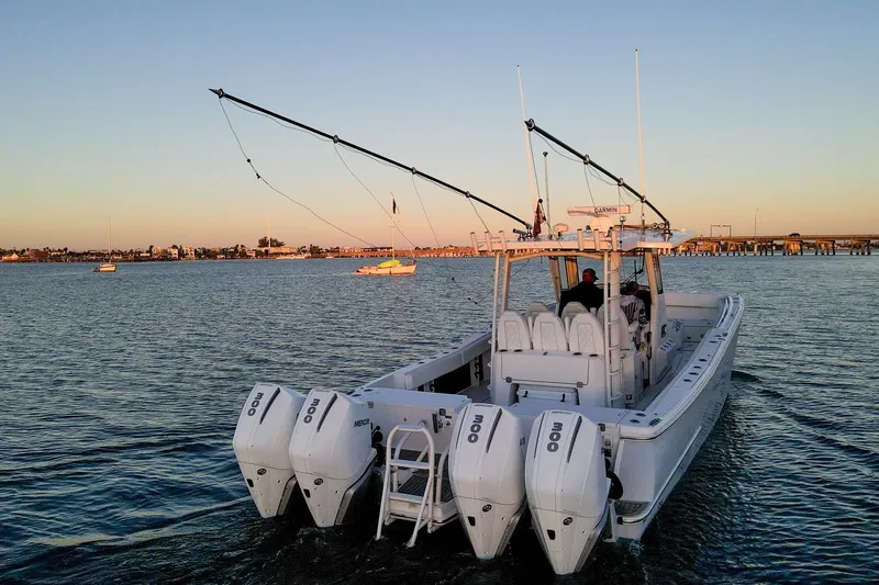 Slide: The Image of 2022 World Cat 400 CC-X boat cruising on calm waters at sunset. - 5