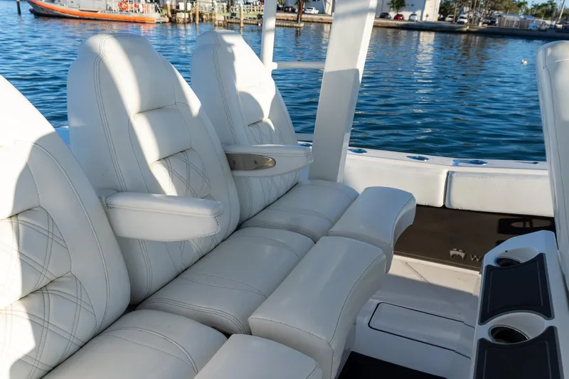 Slide: The Image of Luxurious seating on 2022 World Cat 400 CC-X boat, docked by the water. - 50