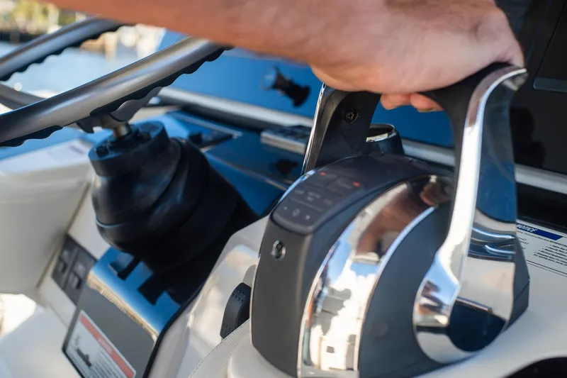 Slide: The Image of Close-up of 2022 World Cat 400 CC-X boat controls and steering wheel. - 54