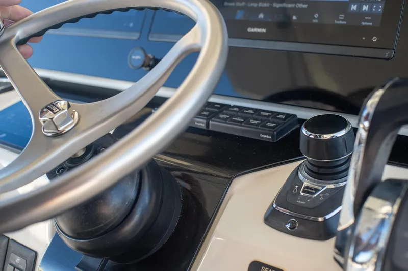 Slide: The Image of Steering wheel and controls of 2022 World Cat 400 CC-X boat cockpit. - 55