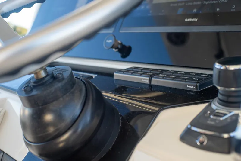 Slide: The Image of Close-up of 2022 World Cat 400 CC-X boat dashboard with steering wheel and controls. - 56