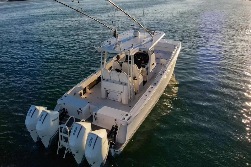 Slide: The Image of 2022 World Cat 400 CC-X boat on calm water, featuring dual outboard engines. - 9