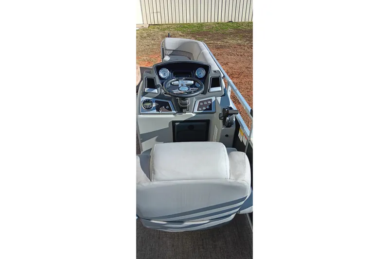 Slide: The Image of 2023 Ranger Reata 223C boat cockpit with steering wheel and controls. - 12