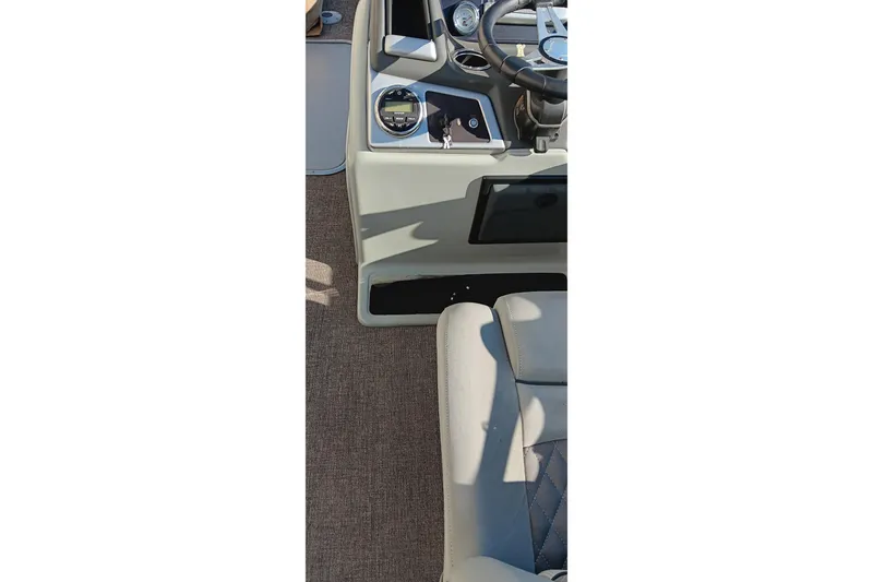 Slide: The Image of 2023 Ranger Reata 223C boat interior with steering wheel and dashboard controls. - 13