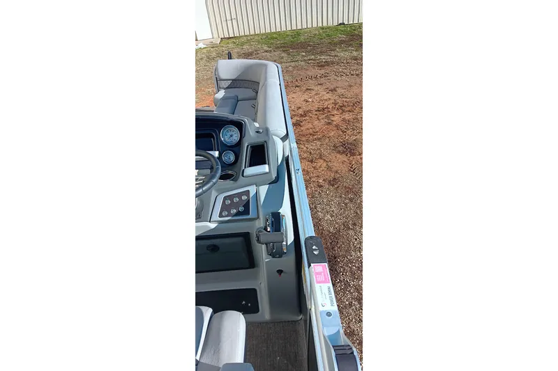 Slide: The Image of 2023 Ranger Reata 223C boat interior with steering console and seating. - 14