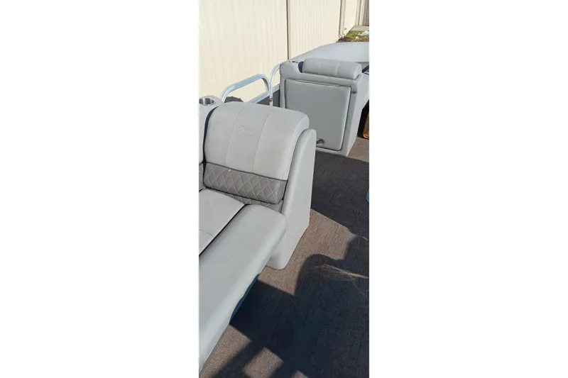 Slide: The Image of 2023 Ranger Reata 223C boat interior with gray cushioned seating. - 17