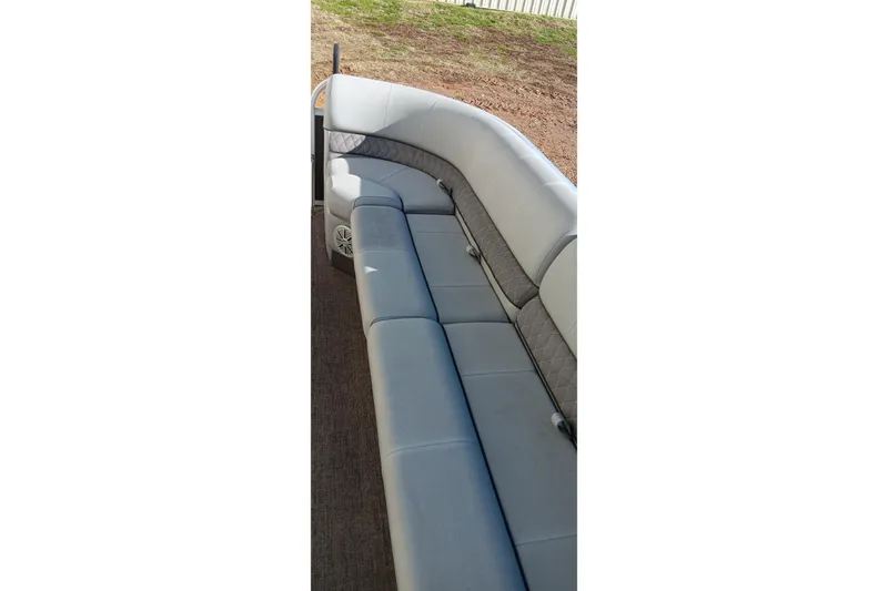 Slide: The Image of 2023 Ranger Reata 223C boat interior with gray cushioned seating. - 18