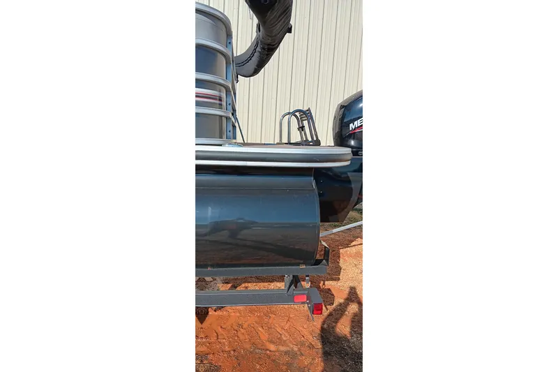 Slide: The Image of 2023 Ranger Reata 223C pontoon boat rear view with motor and trailer. - 2