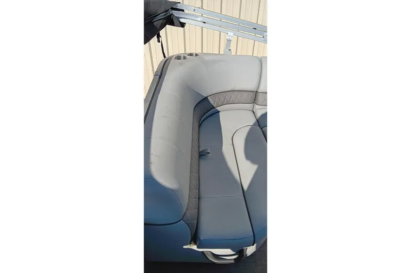 Slide: The Image of 2023 Ranger Reata 223C boat interior with gray seating and cup holders. - 21