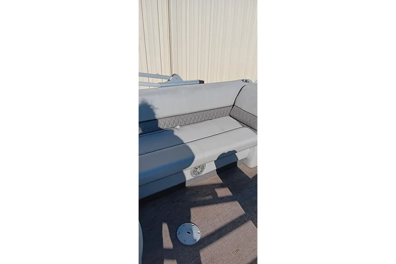 Slide: The Image of 2023 Ranger Reata 223C boat interior with gray seating and shadow. - 22