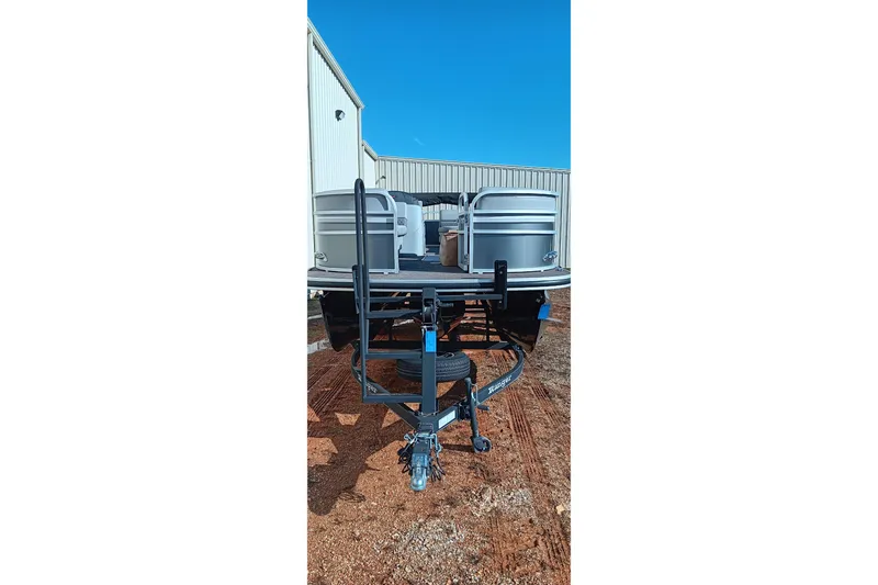 Slide: The Image of 2023 Ranger Reata 223C pontoon boat on trailer, parked outdoors. - 24