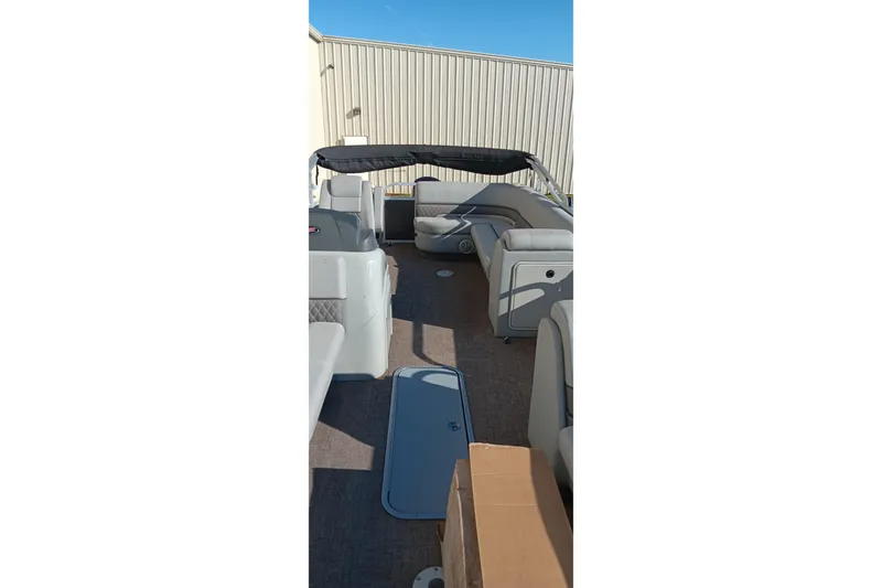 Slide: The Image of 2023 Ranger Reata 223C pontoon boat interior with seating and canopy. - 27