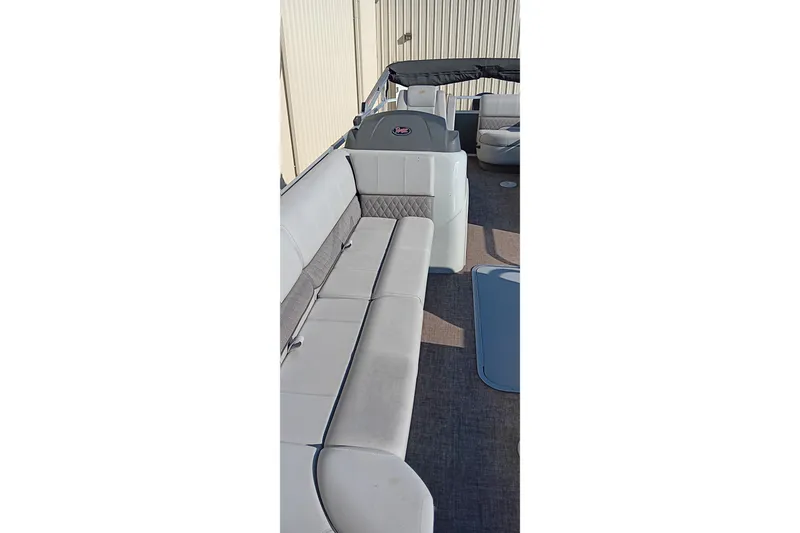 Slide: The Image of 2023 Ranger Reata 223C pontoon boat interior with plush seating and modern design. - 28