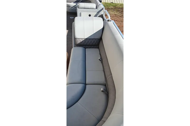 Slide: The Image of 2023 Ranger Reata 223C boat interior with gray cushioned seating. - 30