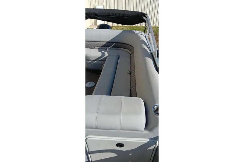 Slide: The Image of 2023 Ranger Reata 223C boat interior with gray seating and cup holders. - 33
