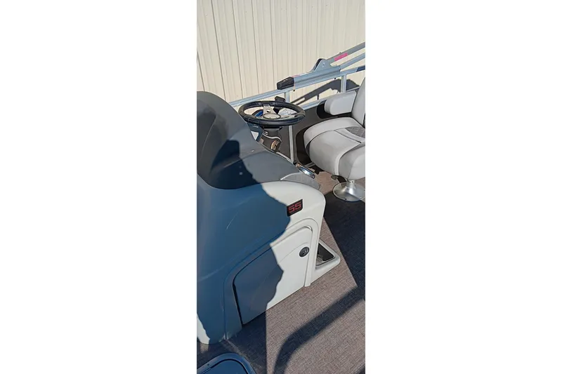 Slide: The Image of 2023 Ranger Reata 223C boat interior with steering wheel and seating. - 35