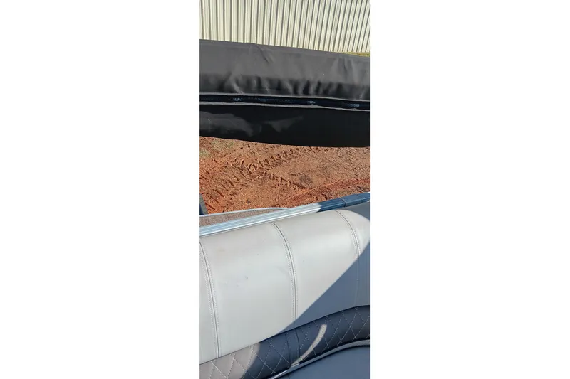 Slide: The Image of 2023 Ranger Reata 223C boat interior with leather seating and outdoor view. - 38