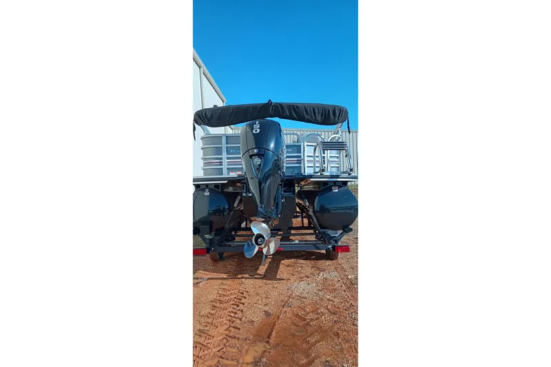 Slide: The Image of 2023 Ranger Reata 223C boat with outboard motor, parked on a trailer. - 7