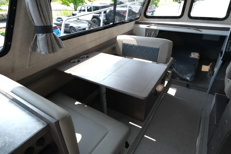 Slide: The Image of Interior of 2026 KingFisher 3025 XRS boat with seating and table setup. - 11