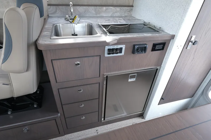 Slide: The Image of Compact kitchenette in 2026 KingFisher 3025 XRS with sink, stove, and storage drawers. - 13