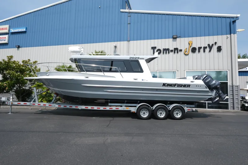 Slide: The Image of 2026 KingFisher 3025 XRS boat on trailer outside dealership. - 2