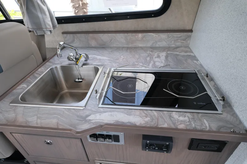 Slide: The Image of Modern kitchen area in 2026 KingFisher 3025 XRS boat with sink and stove. - 22