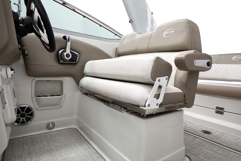 Slide: The Image of 2026 Crownline 270 CR boat interior with beige seating and modern controls. - 11