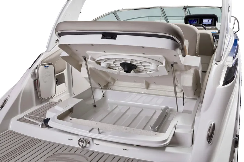 Slide: The Image of 2026 Crownline 270 CR boat with open storage compartment and modern dashboard. - 15