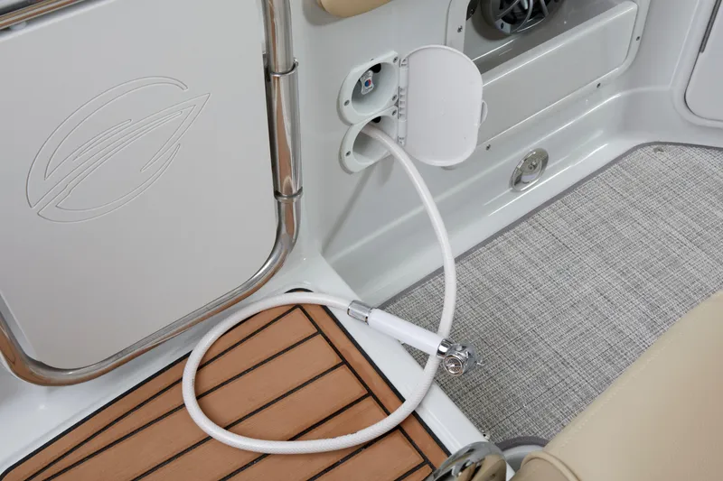 Slide: The Image of 2026 Crownline 270 CR boat interior with shower hose and teak flooring. - 4
