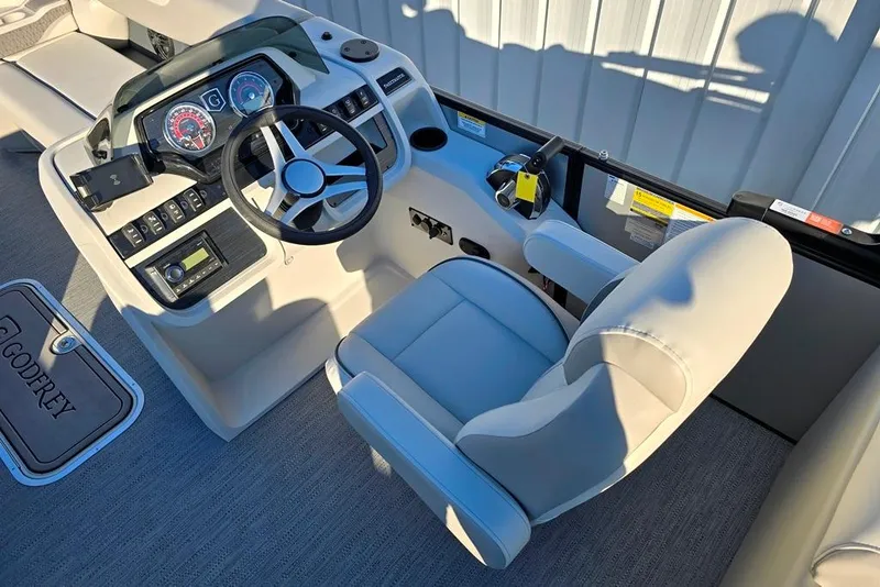 Slide: The Image of Captain's helm of 2026 Sweetwater 2286 SBC boat with steering wheel and control panel. - 2